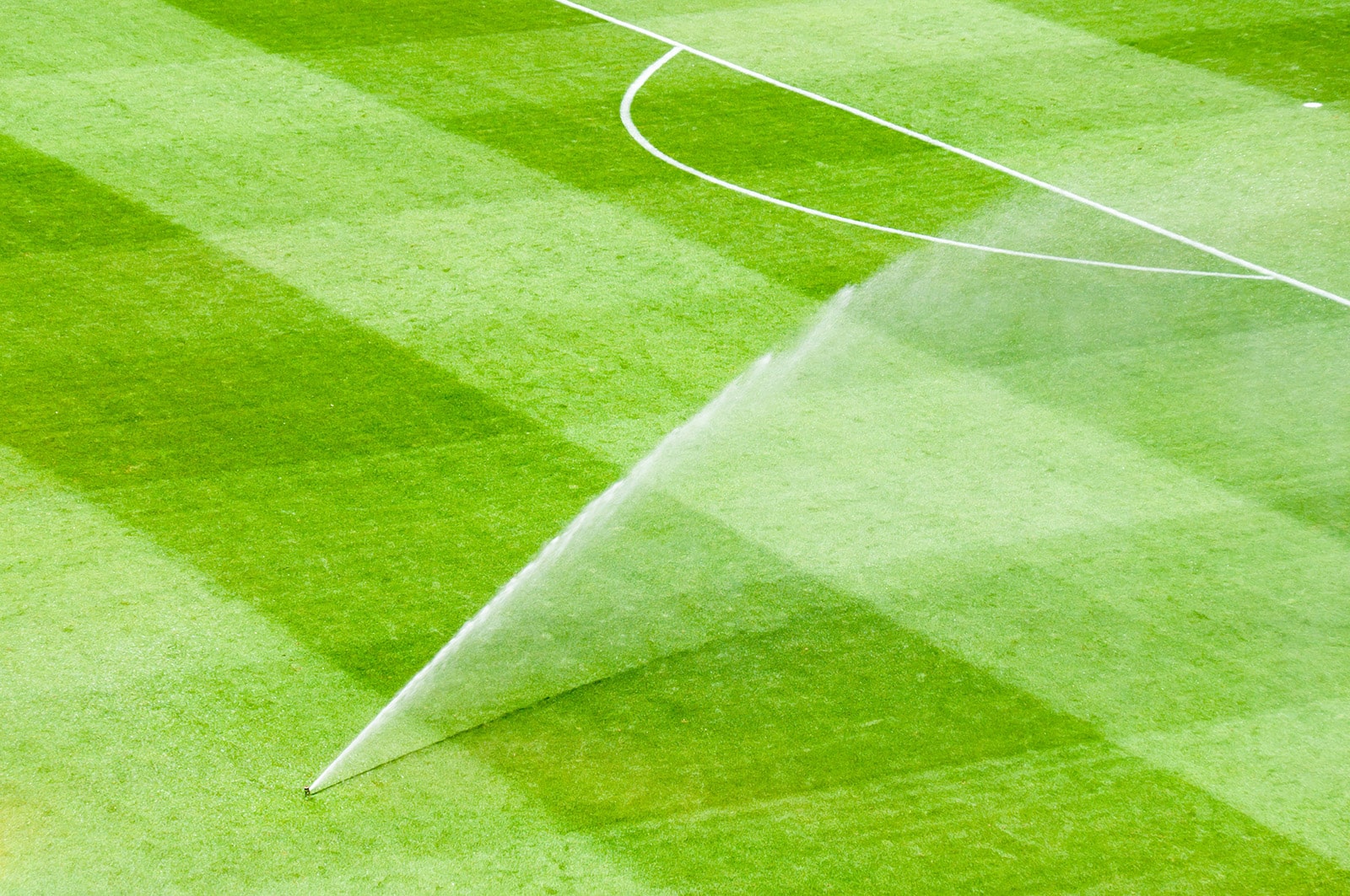 Sprinkler hydrating soccer field.